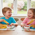 Two kids eating cheese strips
