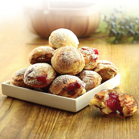 Danish style aebleskiver apple pancakes or pancake puffs served in a cast  iron pan on white rustic boards. - Live Free Creative Co